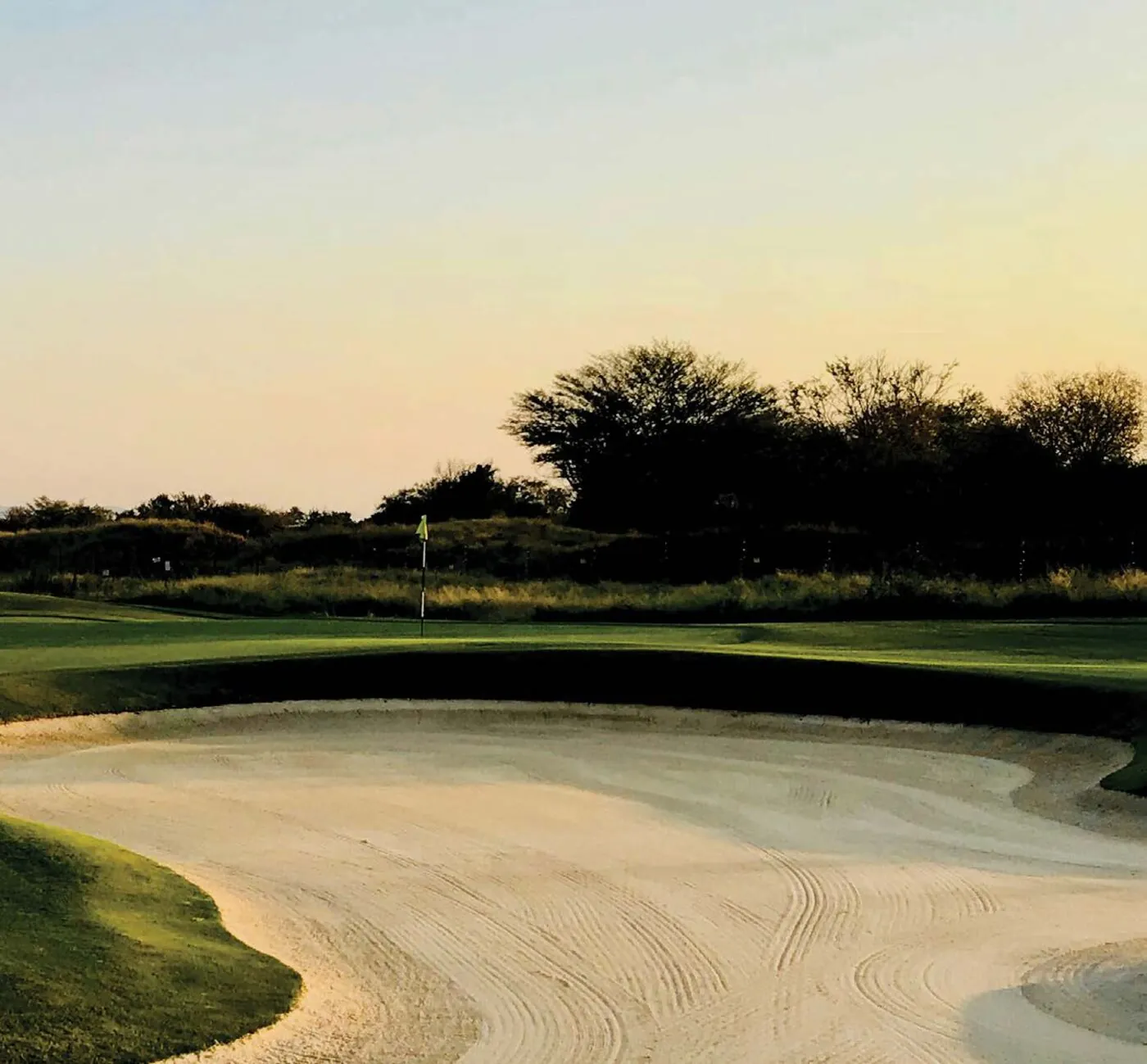 A manicured golf course green at sunset in the Niagara region